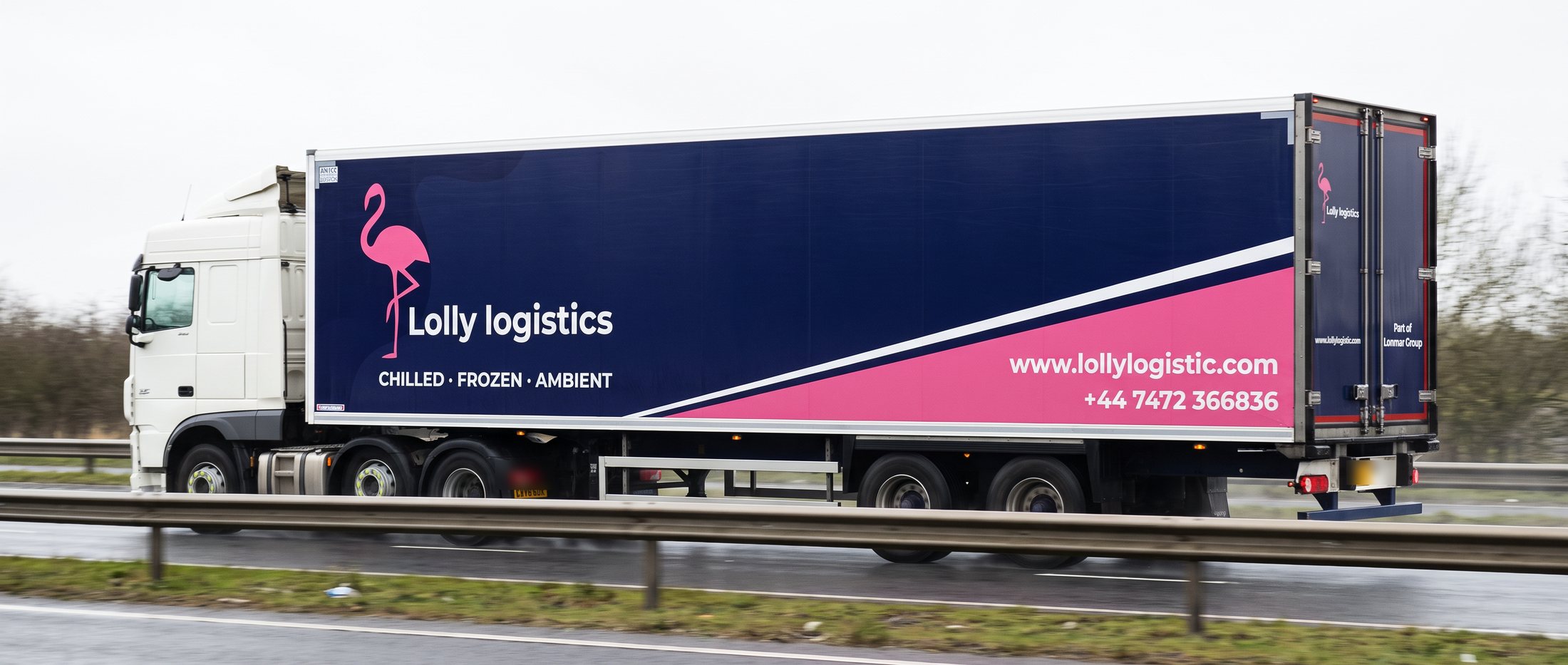 A Lolly Logistics refrigerated trailer on a British dual carriageway
